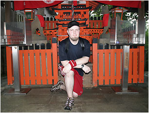 nick in front of a shrine with many mini-torii